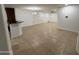 Open living room and kitchen area featuring tile floors and a bar top for dining at 5338 W Wolf St, Phoenix, AZ 85031