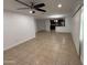 Open-concept living space features neutral tile flooring, great natural light, and a modern ceiling fan at 5338 W Wolf St, Phoenix, AZ 85031