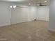 Open living room featuring tile floors, vertical blinds, a chandelier, and a ceiling fan at 5338 W Wolf St, Phoenix, AZ 85031