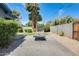 Backyard featuring a fire pit, gravel, plants, and a large palm tree at 534 W 15Th St, Tempe, AZ 85281