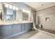 Elegant bathroom with double sinks, a walk-in shower, and gray wood-look flooring at 534 W 15Th St, Tempe, AZ 85281