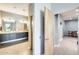 Well-lit bathroom with double sinks, granite countertops, and gray wood-look flooring at 534 W 15Th St, Tempe, AZ 85281
