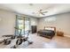 Bright bedroom with gym equipment, wood-look floors, and a private patio entrance at 534 W 15Th St, Tempe, AZ 85281
