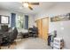 A bedroom with an office setup, a ceiling fan, and a closet with wood doors at 534 W 15Th St, Tempe, AZ 85281