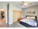 Cozy bedroom with a ceiling fan, wood-look flooring, and a closet with sliding doors at 534 W 15Th St, Tempe, AZ 85281