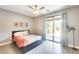 Modern bedroom featuring a ceiling fan, sliding glass doors, and gray wood-look flooring at 534 W 15Th St, Tempe, AZ 85281