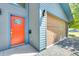 View of the charming home's front entrance featuring a vibrant orange door and a convenient attached two-car garage at 534 W 15Th St, Tempe, AZ 85281