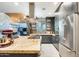 Gourmet kitchen featuring stainless steel appliances, a center island, granite countertops and dark cabinetry at 534 W 15Th St, Tempe, AZ 85281