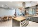 An expansive kitchen with island cooktop adjoins a dining area and a living room at 534 W 15Th St, Tempe, AZ 85281