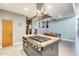 Kitchen island cooktop with modern vent hood and adjacent dining area in an open-concept design at 534 W 15Th St, Tempe, AZ 85281
