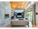 Bright living room with a stone accent wall fireplace, modern furnishings and vaulted wood ceilings at 534 W 15Th St, Tempe, AZ 85281