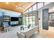 Open-concept living room with wood-paneled ceilings, a modern entertainment center, and access to the outdoor space at 534 W 15Th St, Tempe, AZ 85281