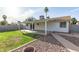 Spacious backyard featuring a covered patio and a well-maintained lawn at 6873 E Kathleen Rd, Scottsdale, AZ 85254