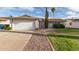 Charming single-story home featuring a well-manicured front yard, desert landscaping, and a two-car garage at 6873 E Kathleen Rd, Scottsdale, AZ 85254