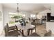 Bright kitchen with white cabinetry, tile floors, and a modern dining area with backyard views at 6873 E Kathleen Rd, Scottsdale, AZ 85254