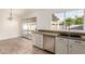 This lovely kitchen features granite countertops, stainless steel appliances, and a view of the backyard at 6873 E Kathleen Rd, Scottsdale, AZ 85254