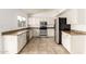 Spacious kitchen boasts white cabinets, granite counters, stainless steel appliances, and tile flooring at 6873 E Kathleen Rd, Scottsdale, AZ 85254