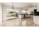 Bright kitchen featuring white cabinets, granite countertops, stainless steel appliances, and a sliding glass door at 6873 E Kathleen Rd, Scottsdale, AZ 85254