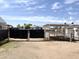 Chain link gate with shade cloth and a backyard with dirt landscaping at 6950 W Karen Lee Ln, Peoria, AZ 85382