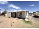 White mobile home with an attached covered porch, on a large lot with desert landscaping at 6950 W Karen Lee Ln, Peoria, AZ 85382