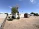 White mobile home with an attached screen porch, surrounded by chain link fencing and desert landscaping at 6950 W Karen Lee Ln, Peoria, AZ 85382