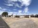 Wide angle shot of the mobile home with a chain-link fence surrounding the perimeter at 6950 W Karen Lee Ln, Peoria, AZ 85382