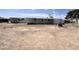 Mobile home exterior showing a large lot with desert landscaping, surrounded by chain link fencing at 6950 W Karen Lee Ln, Peoria, AZ 85382