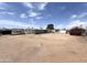 Mobile home exterior featuring a large lot with desert landscaping, surrounded by chain link fencing at 6950 W Karen Lee Ln, Peoria, AZ 85382