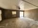 Large living room with sliding glass door and fan provides plenty of natural light at 6950 W Karen Lee Ln, Peoria, AZ 85382