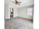 Spacious bedroom with neutral carpet and ample natural light from a large window at 7117 W Globe Ave, Phoenix, AZ 85043