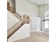 Bright entryway showcases a staircase with wooden banisters and natural lighting from a large arched window at 7117 W Globe Ave, Phoenix, AZ 85043