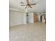 Open-concept living space with tile flooring leads to the kitchen area and has a ceiling fan at 7117 W Globe Ave, Phoenix, AZ 85043