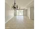 Spacious living room with tile flooring features access to the backyard through large sliding glass doors at 7117 W Globe Ave, Phoenix, AZ 85043