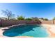 Refreshing pool with decorative water feature, surrounded by a brick wall, offers a private outdoor oasis at 7117 W Globe Ave, Phoenix, AZ 85043