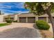 Charming townhomes featuring private garages, well-maintained landscaping, and inviting curb appeal with desert flora at 7700 E Gainey Ranch Rd # 102, Scottsdale, AZ 85258