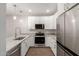 Updated kitchen with granite countertops, stainless steel appliances, and modern white cabinetry at 7700 E Gainey Ranch Rd # 102, Scottsdale, AZ 85258