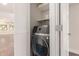 Laundry room features a modern washer and dryer with storage shelf at 7700 E Gainey Ranch Rd # 102, Scottsdale, AZ 85258