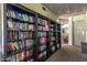 Well-stocked library with shelves of books and cozy seating for reading, adjacent to a bright social area at 7700 E Gainey Ranch Rd # 102, Scottsdale, AZ 85258