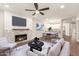 Staged living room showcasing fireplace and open concept to dining and kitchen at 7700 E Gainey Ranch Rd # 102, Scottsdale, AZ 85258