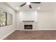 Living room highlighting the stone fireplace and abundant natural light at 7700 E Gainey Ranch Rd # 102, Scottsdale, AZ 85258