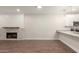 Inviting living room with a stone fireplace, wood-look tile flooring, and an eat-in kitchen area at 7700 E Gainey Ranch Rd # 102, Scottsdale, AZ 85258