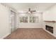 Open living space featuring updated fireplace and large window at 7700 E Gainey Ranch Rd # 102, Scottsdale, AZ 85258