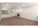 Bright living room with fireplace and large windows offering outdoor views at 7700 E Gainey Ranch Rd # 102, Scottsdale, AZ 85258