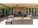 Outdoor patio with comfortable seating around a stone fireplace, perfect for relaxation and gatherings at 7700 E Gainey Ranch Rd # 102, Scottsdale, AZ 85258