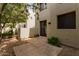 Private patio with mature trees and a desert landscape at 7700 E Gainey Ranch Rd # 102, Scottsdale, AZ 85258