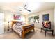 Comfortable bedroom with a decorative bedspread, ceiling fan, and natural light from the window at 7736 E Hazelwood St, Scottsdale, AZ 85251