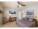 Bedroom with a bed and ceiling fan and two paintings on the wall at 7736 E Hazelwood St, Scottsdale, AZ 85251