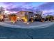Charming single-story home with desert landscaping, lit for a stunning evening curb appeal at 7736 E Hazelwood St, Scottsdale, AZ 85251