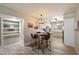 Bright kitchen and adjacent dining area, featuring wood-look tile and a ceiling fan at 7736 E Hazelwood St, Scottsdale, AZ 85251
