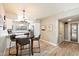 Open floor plan with kitchen and dining area, featuring wood-look tile and modern lighting at 7736 E Hazelwood St, Scottsdale, AZ 85251